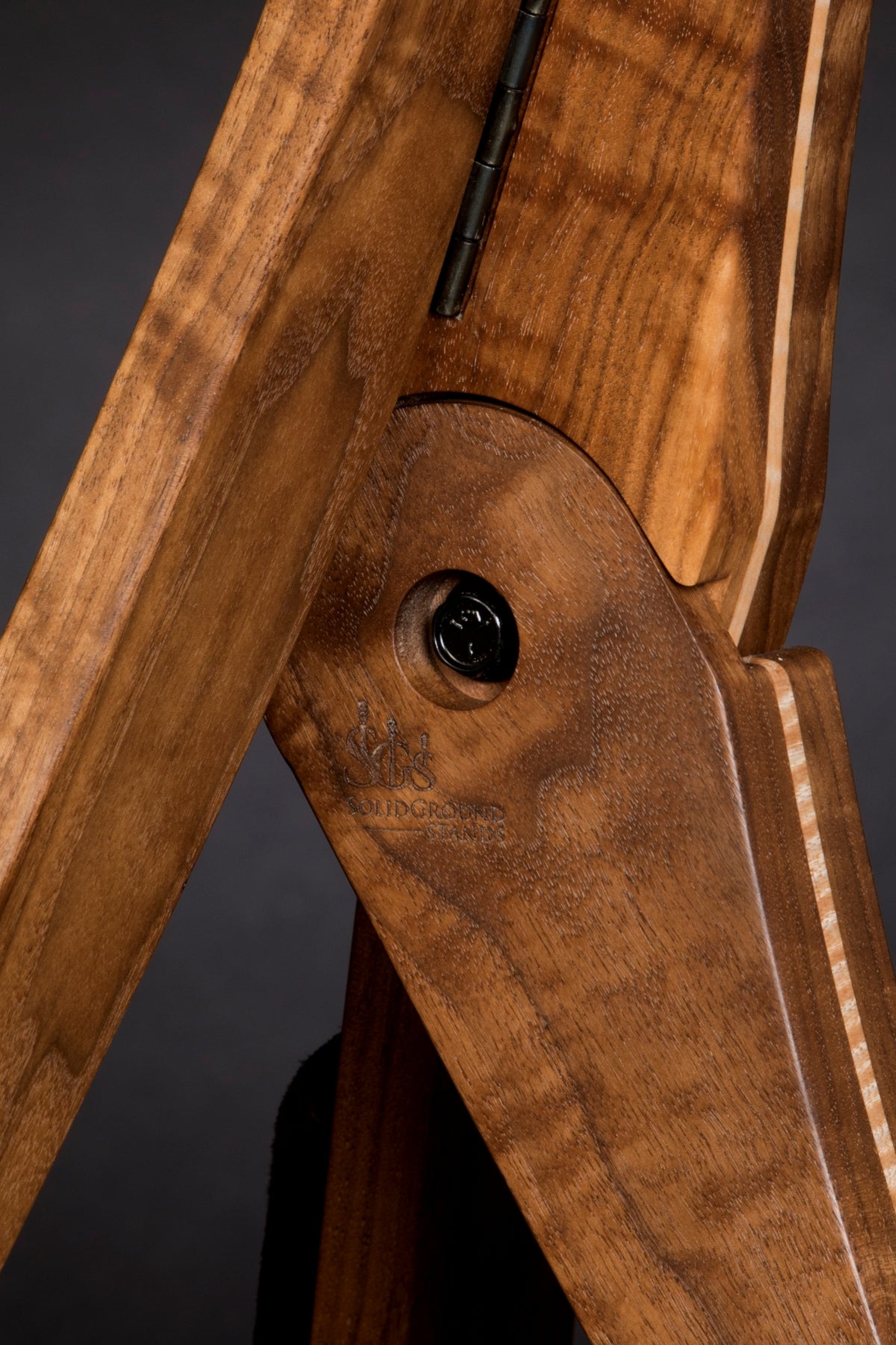 Folding walnut and curly maple wood guitar floor stand joinery detail image