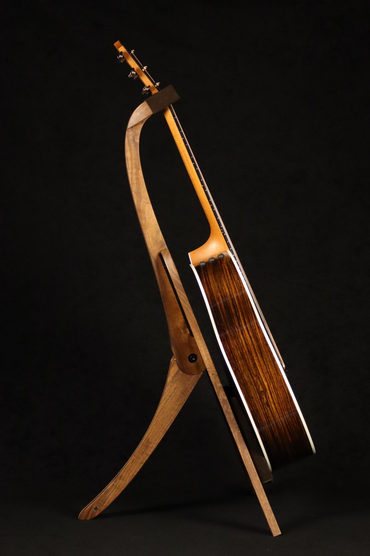Folding walnut and curly maple wood guitar floor stand full side image with Taylor guitar