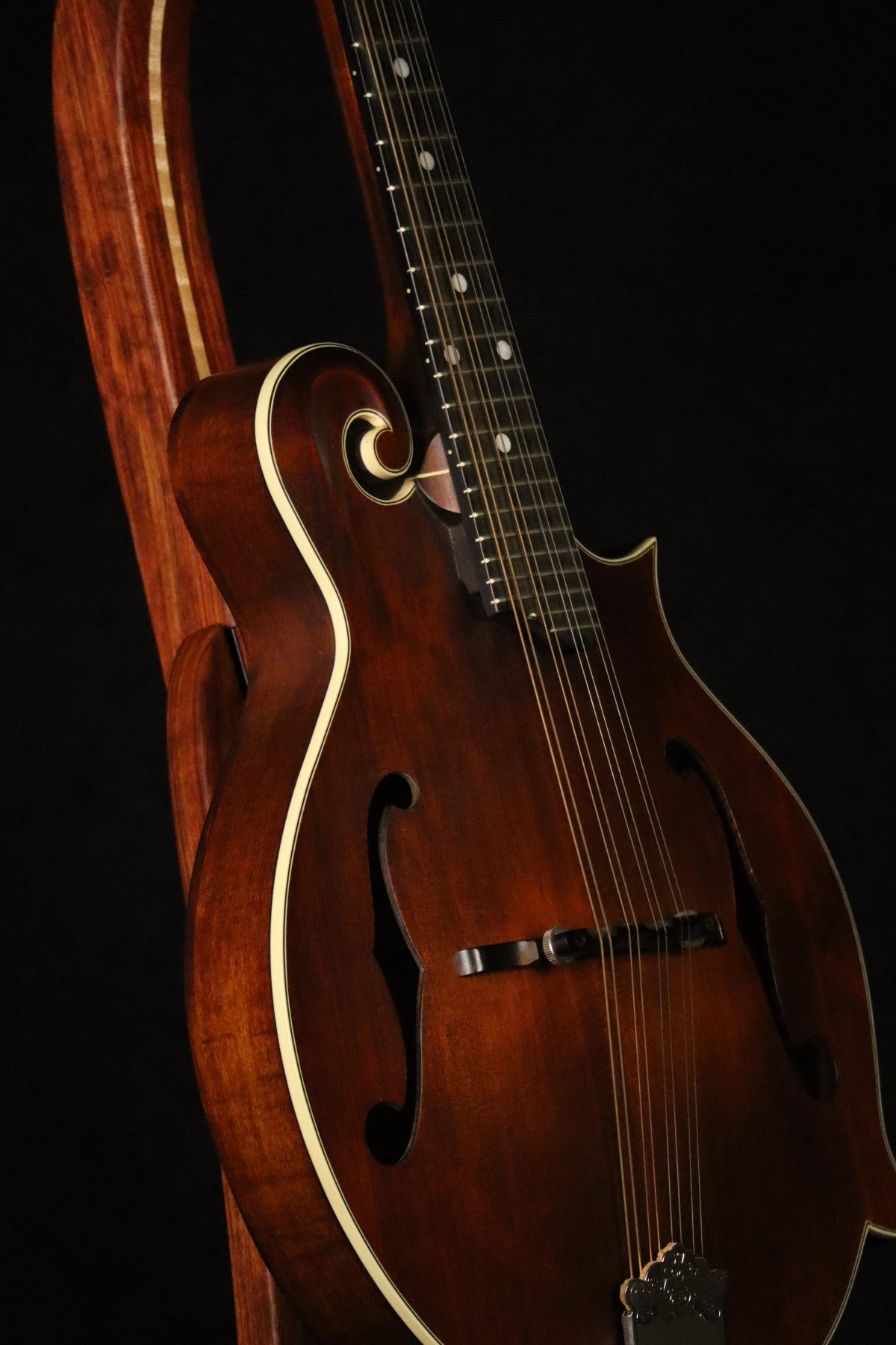 Folding bubinga rosewood and curly maple wood mandolin floor stand closeup front image with Eastman mandolin