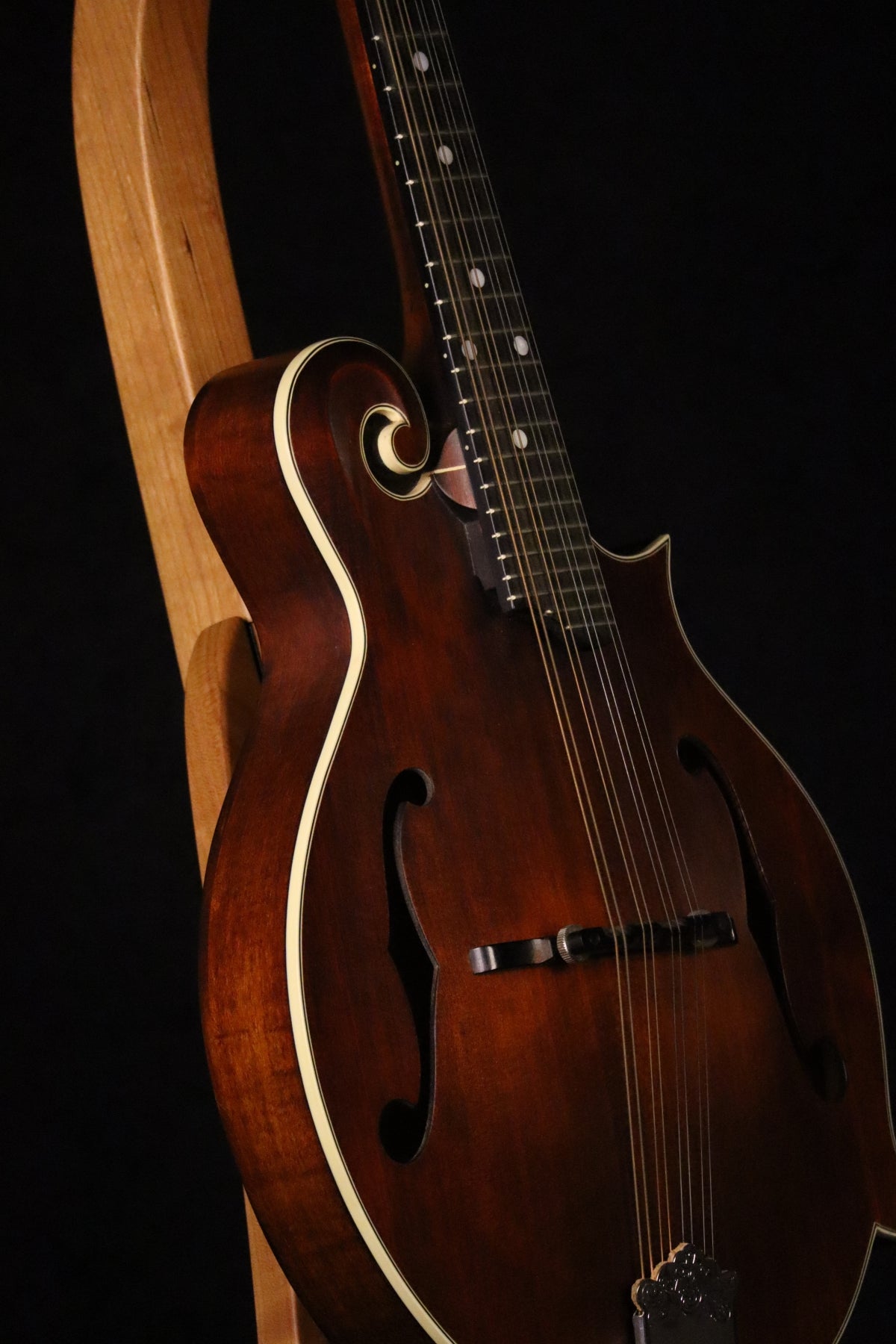 Folding cherry wood mandolin floor stand closeup front image with Eastman mandolin