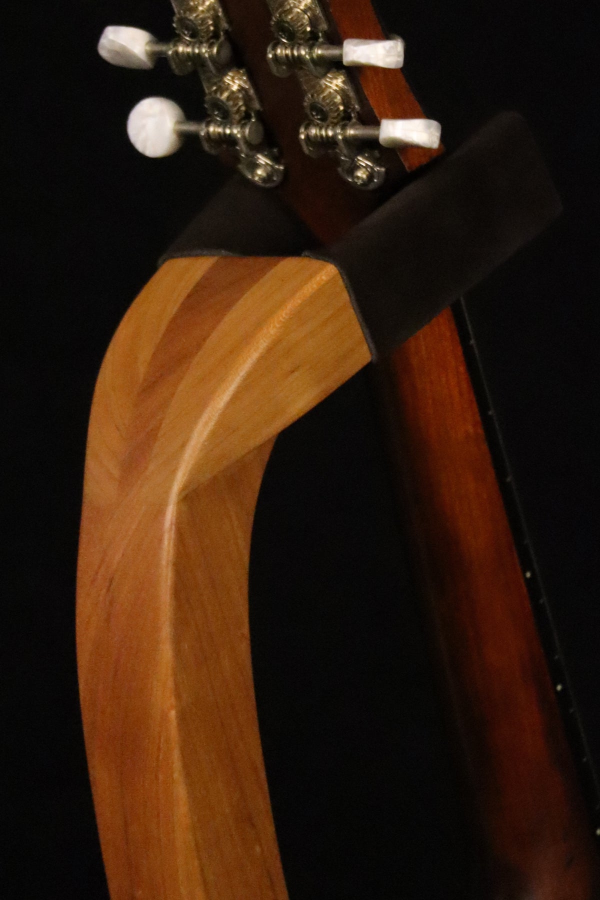 Folding cherry wood mandolin floor stand yoke detail image with Eastman mandolin