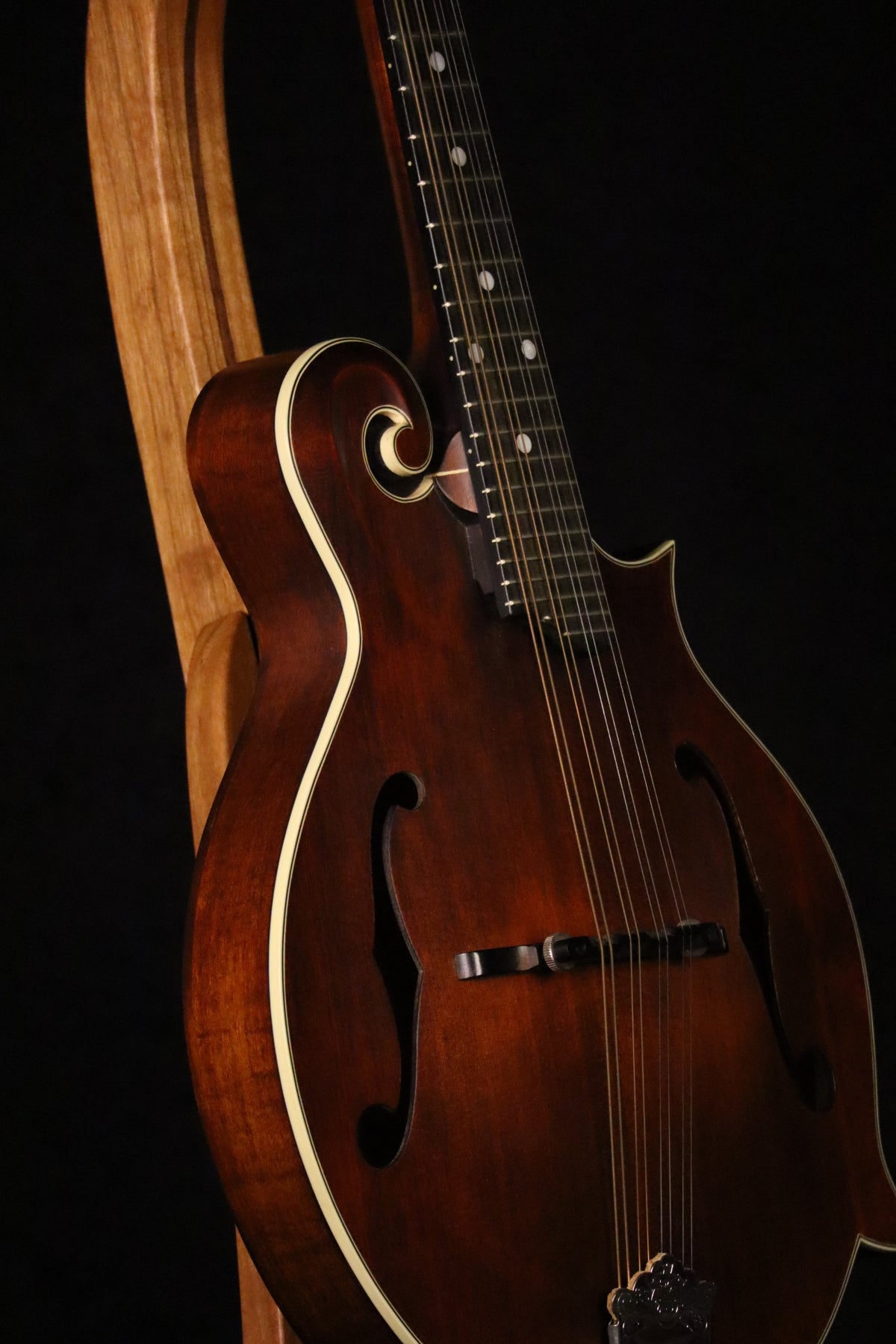 Folding cherry and walnut wood mandolin floor stand closeup front image with Eastman mandolin