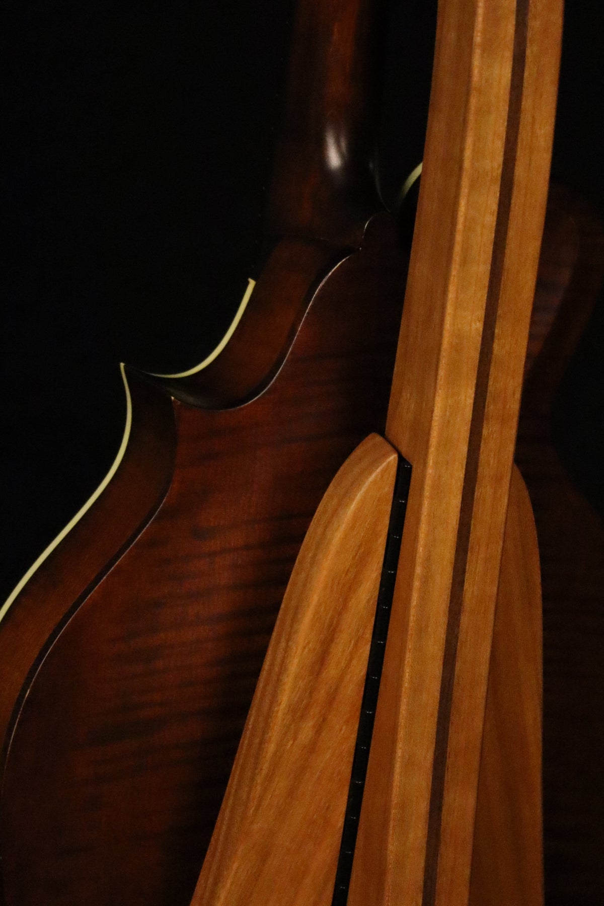 Folding cherry and walnut wood mandolin floor stand closeup rear image with Eastman mandolin