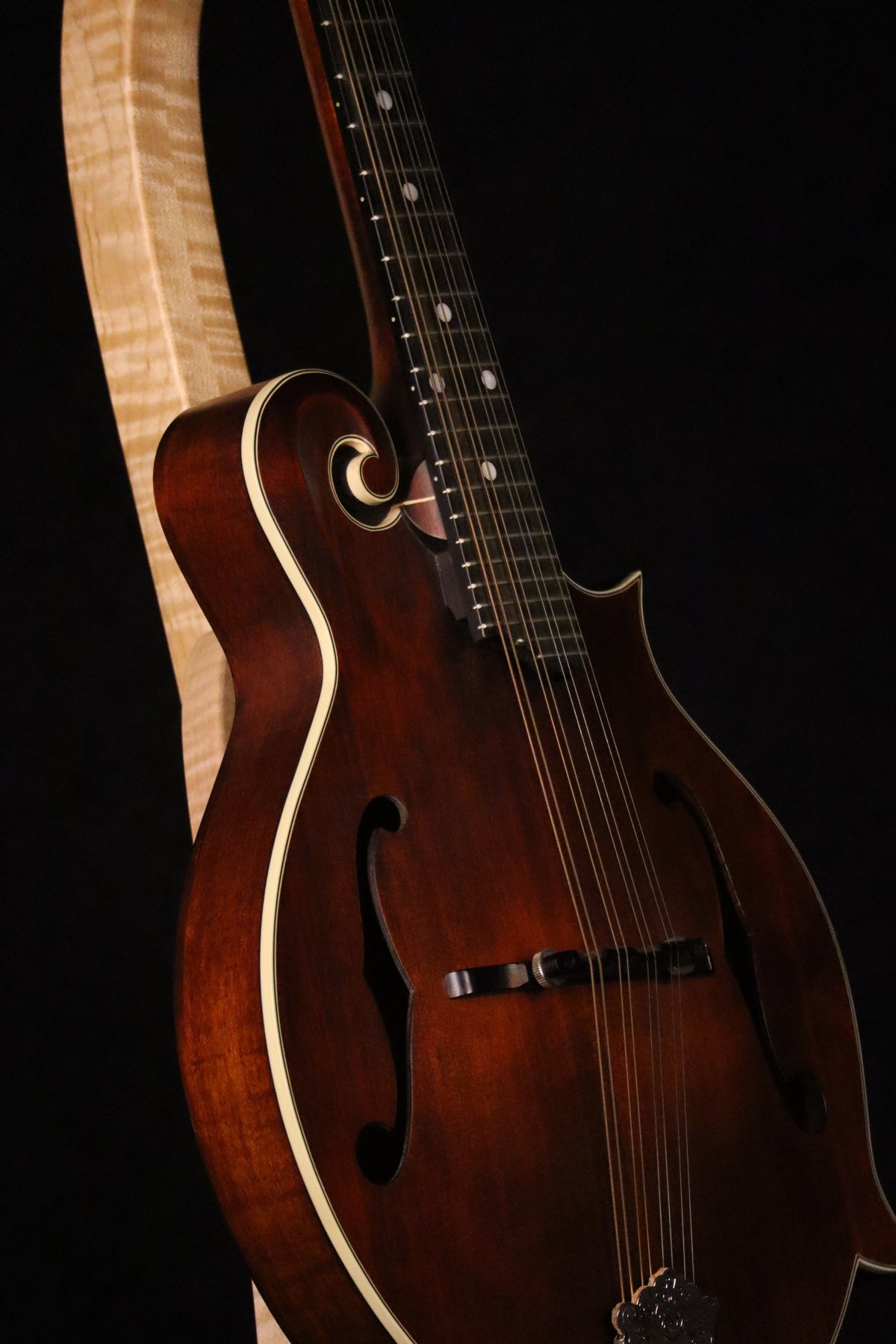 Folding curly maple wood mandolin floor stand closeup front image with Eastman mandolin