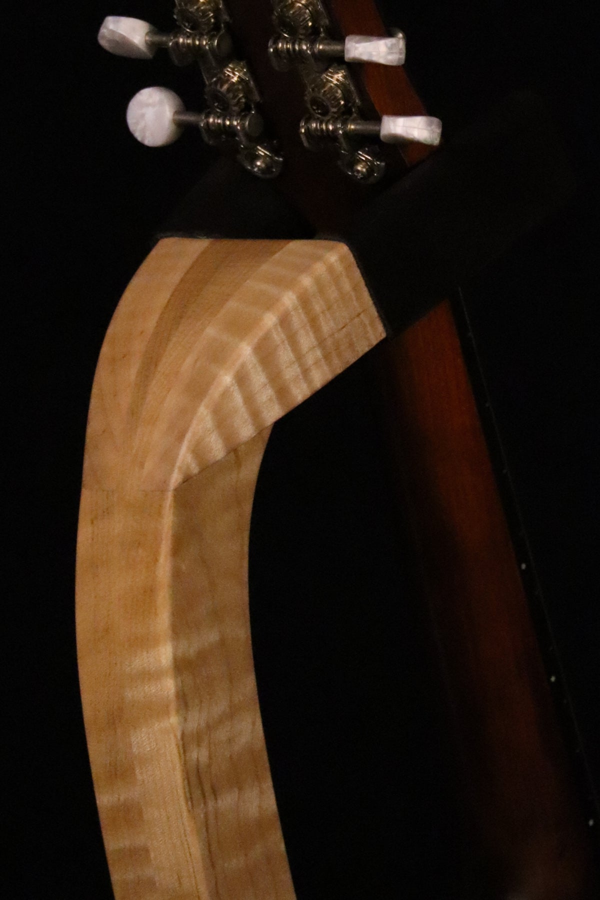 Folding curly maple wood mandolin floor stand yoke detail image with Eastman mandolin