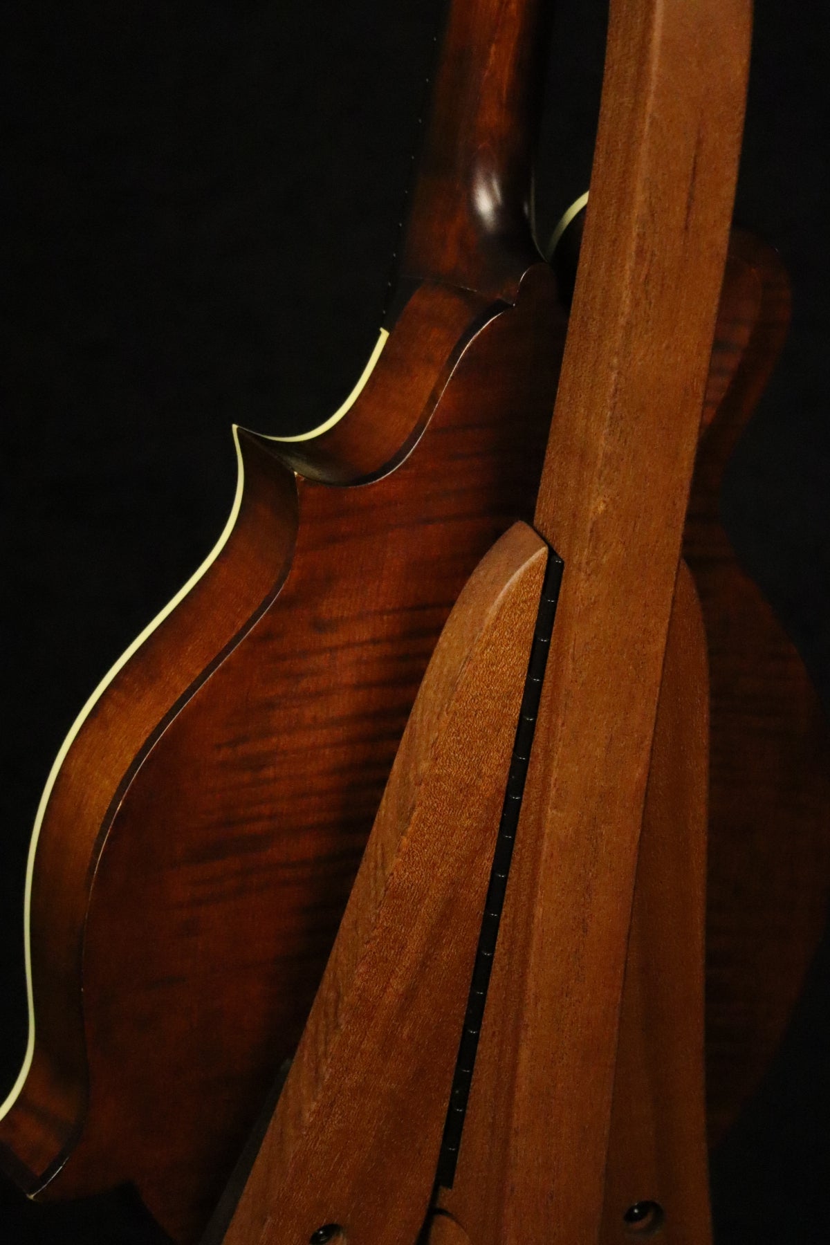 Folding sapele mahogany wood mandolin floor stand closeup rear image with Eastman mandolin