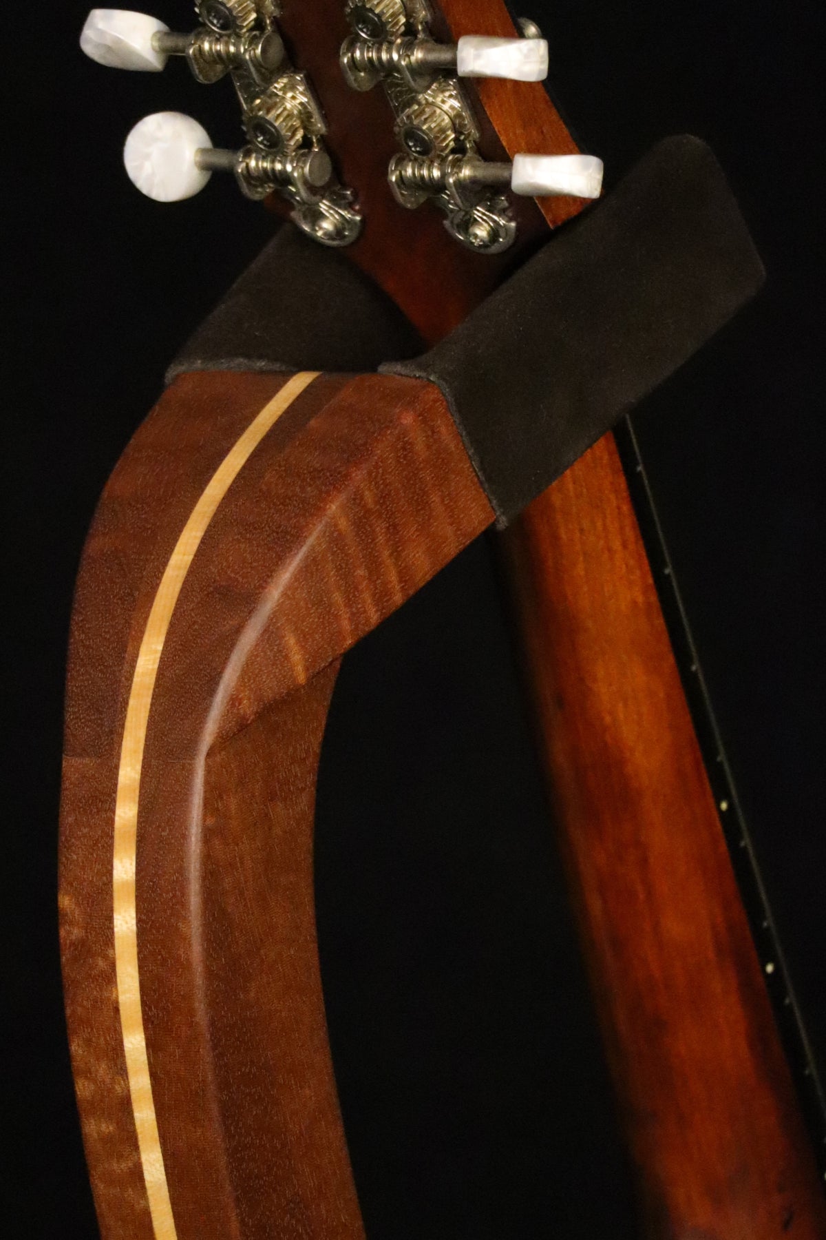 Folding sapele mahogany and curly maple wood mandolin floor stand yoke detail image with Eastman mandolin
