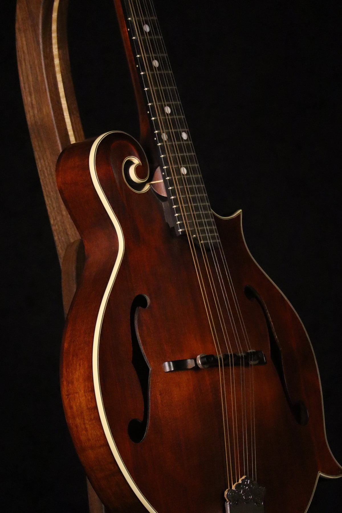 Folding walnut and curly maple wood mandolin floor stand closeup front image with Eastman mandolin