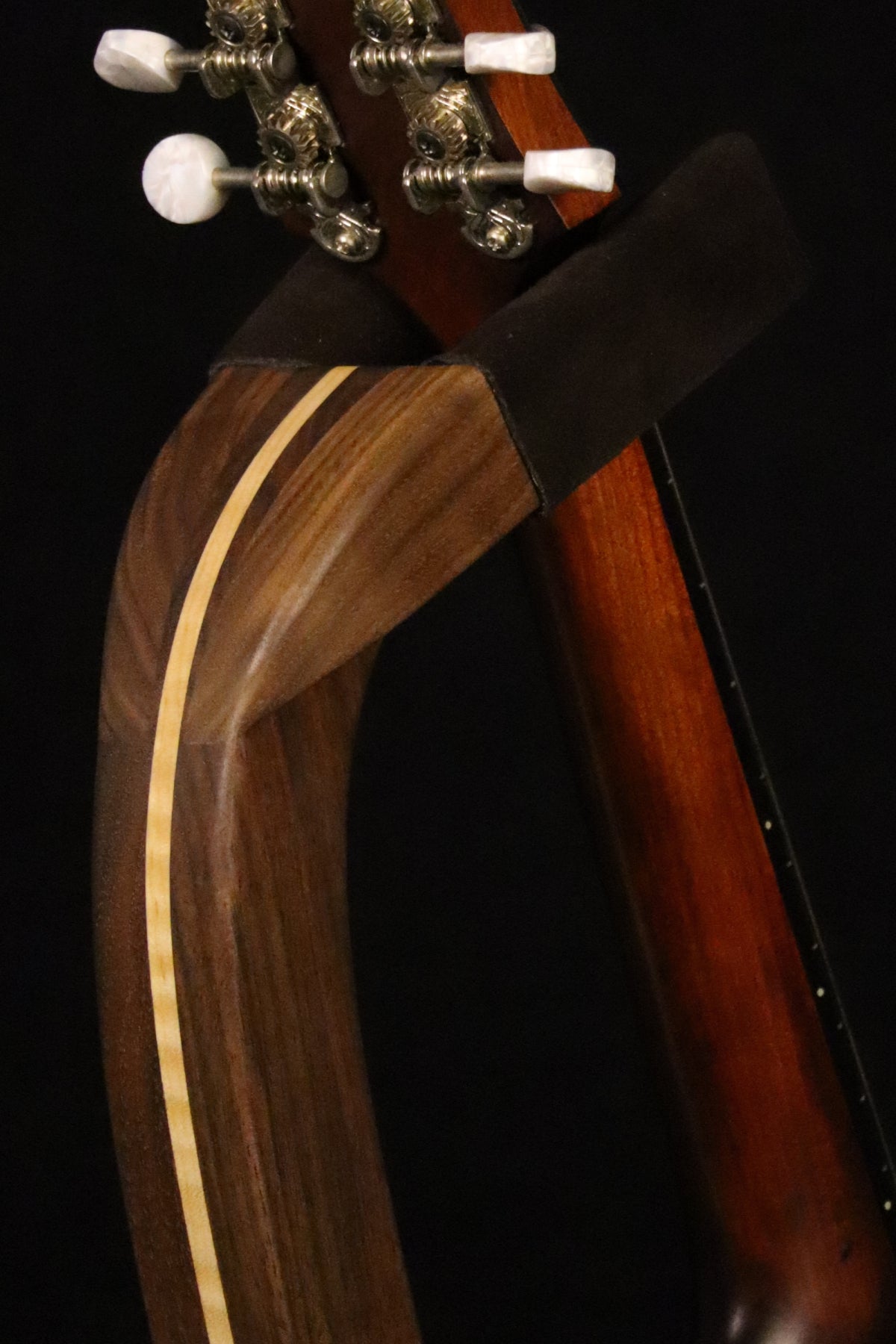 Folding walnut and curly maple wood mandolin floor stand yoke detail image with Eastman mandolin