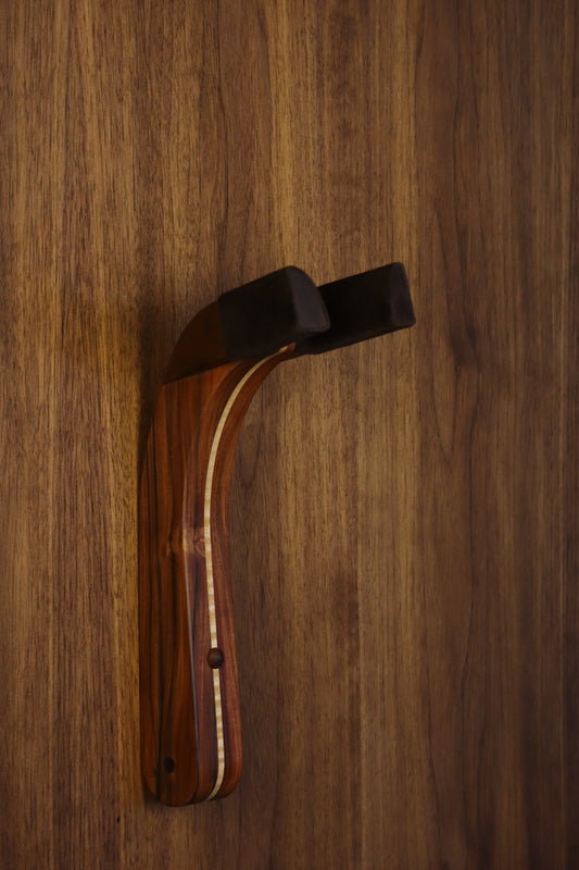 Morado Bolivian rosewood pau fero and curly maple wood guitar wall mount hanger installed on paneled wall