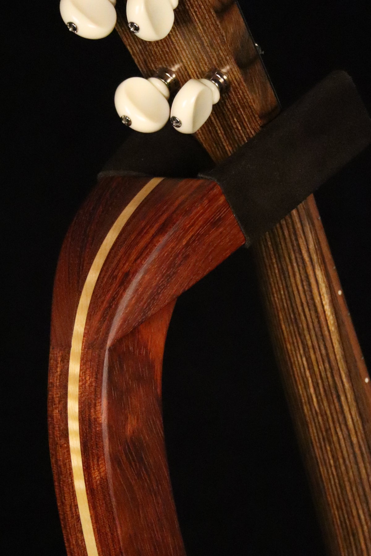 Folding bubinga rosewood and curly maple wood ukulele floor stand yoke detail image with Martin ukulele