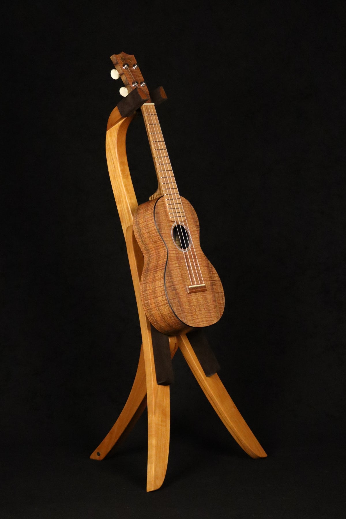Folding cherry wood ukulele floor stand full front image with Martin ukulele