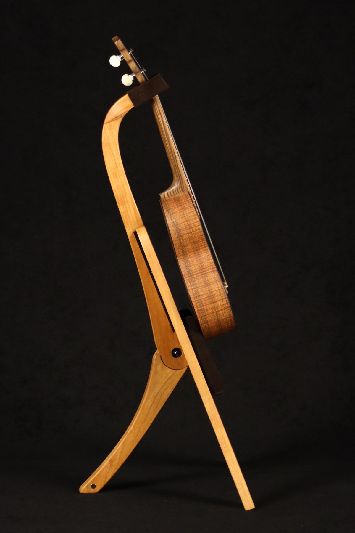 Folding cherry wood ukulele floor stand full side image with Martin ukulele
