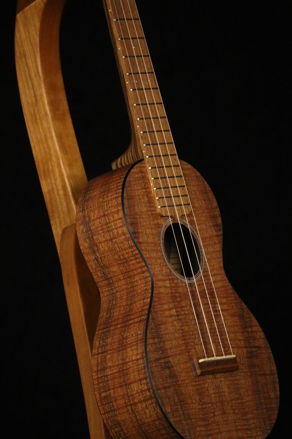 Folding cherry wood ukulele floor stand closeup front image with Martin ukulele