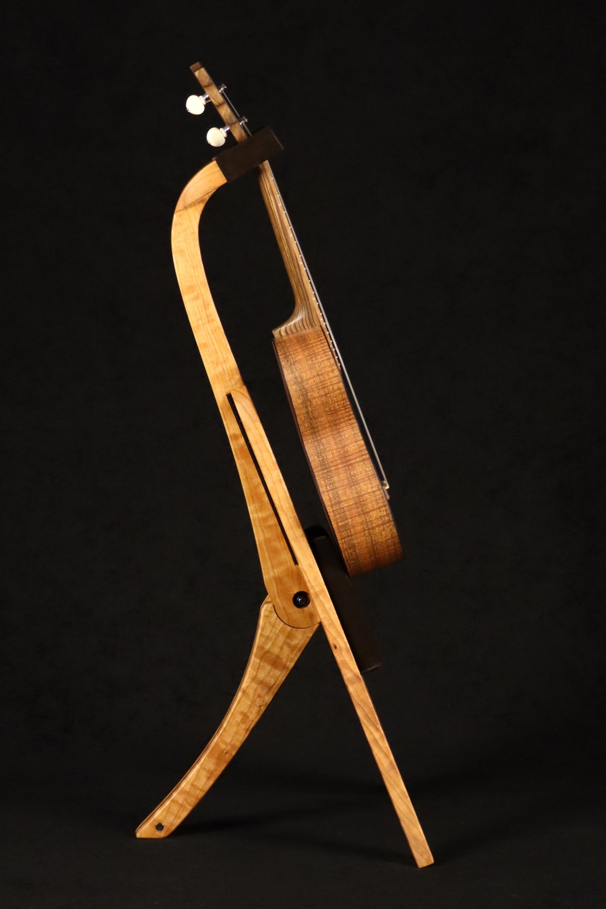 Folding cherry and walnut wood ukulele floor stand full side image with Martin ukulele