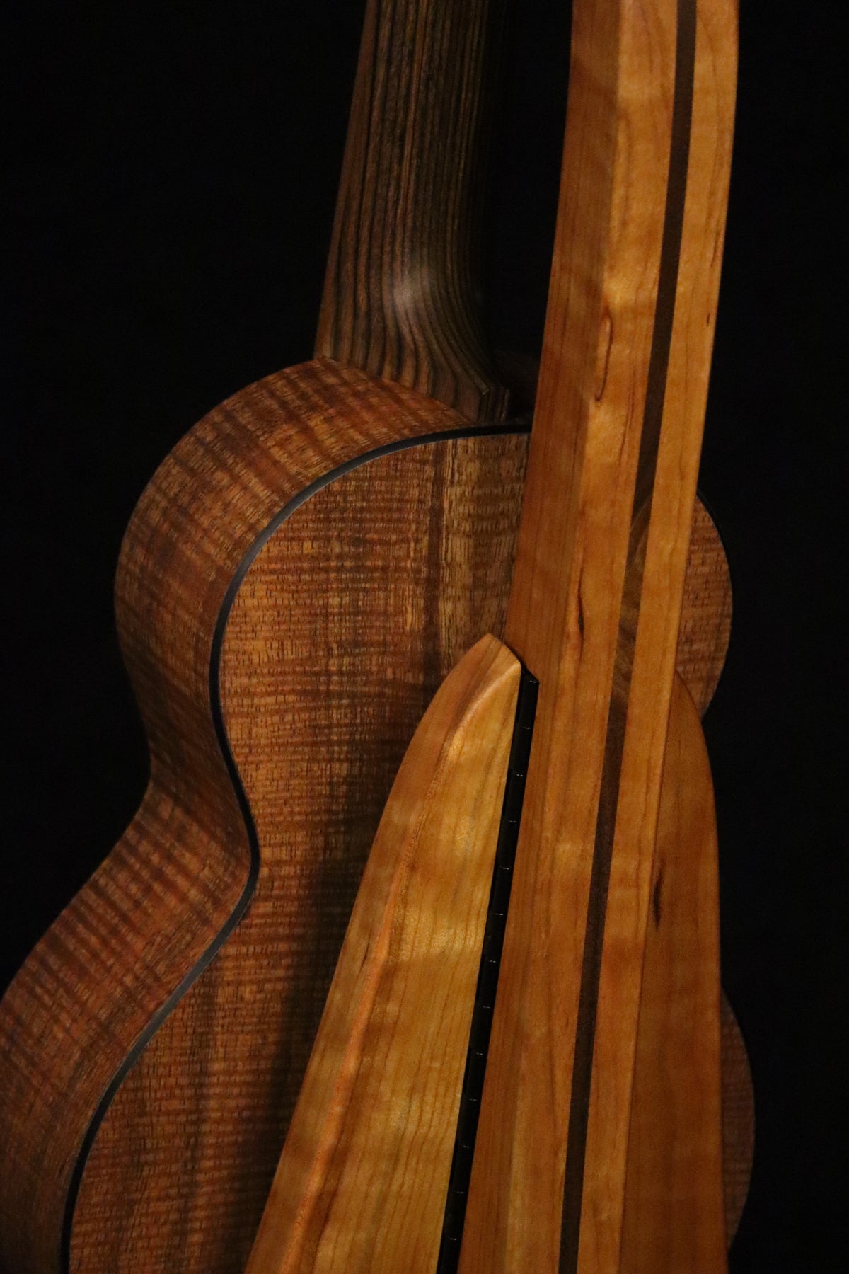 Folding cherry and walnut wood ukulele floor stand closeup rear image with Martin ukulele