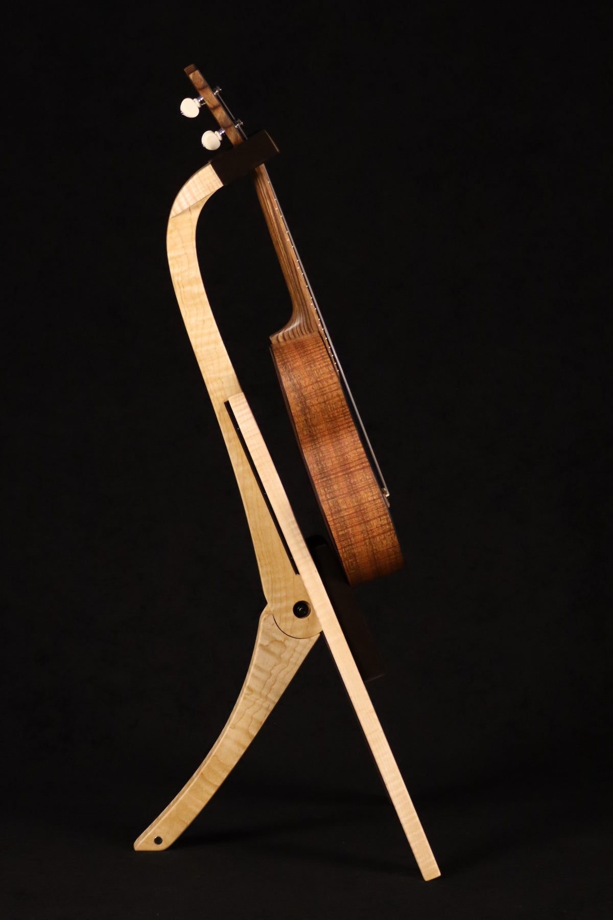 Folding curly maple wood ukulele floor stand full side image with Martin ukulele