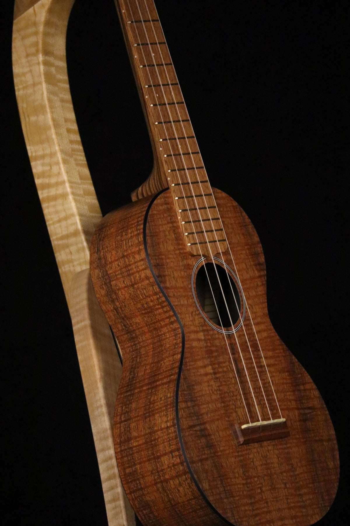 Folding curly maple wood ukulele floor stand closeup front image with Martin ukulele