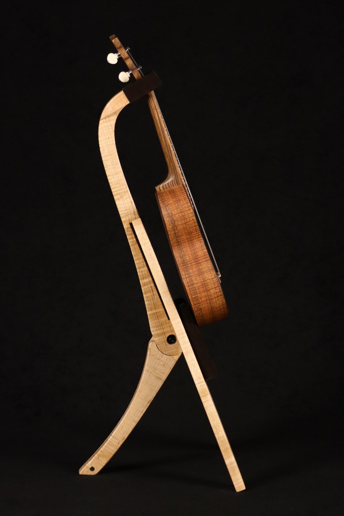 Folding curly maple and walnut wood ukulele floor stand full side image with Martin ukulele