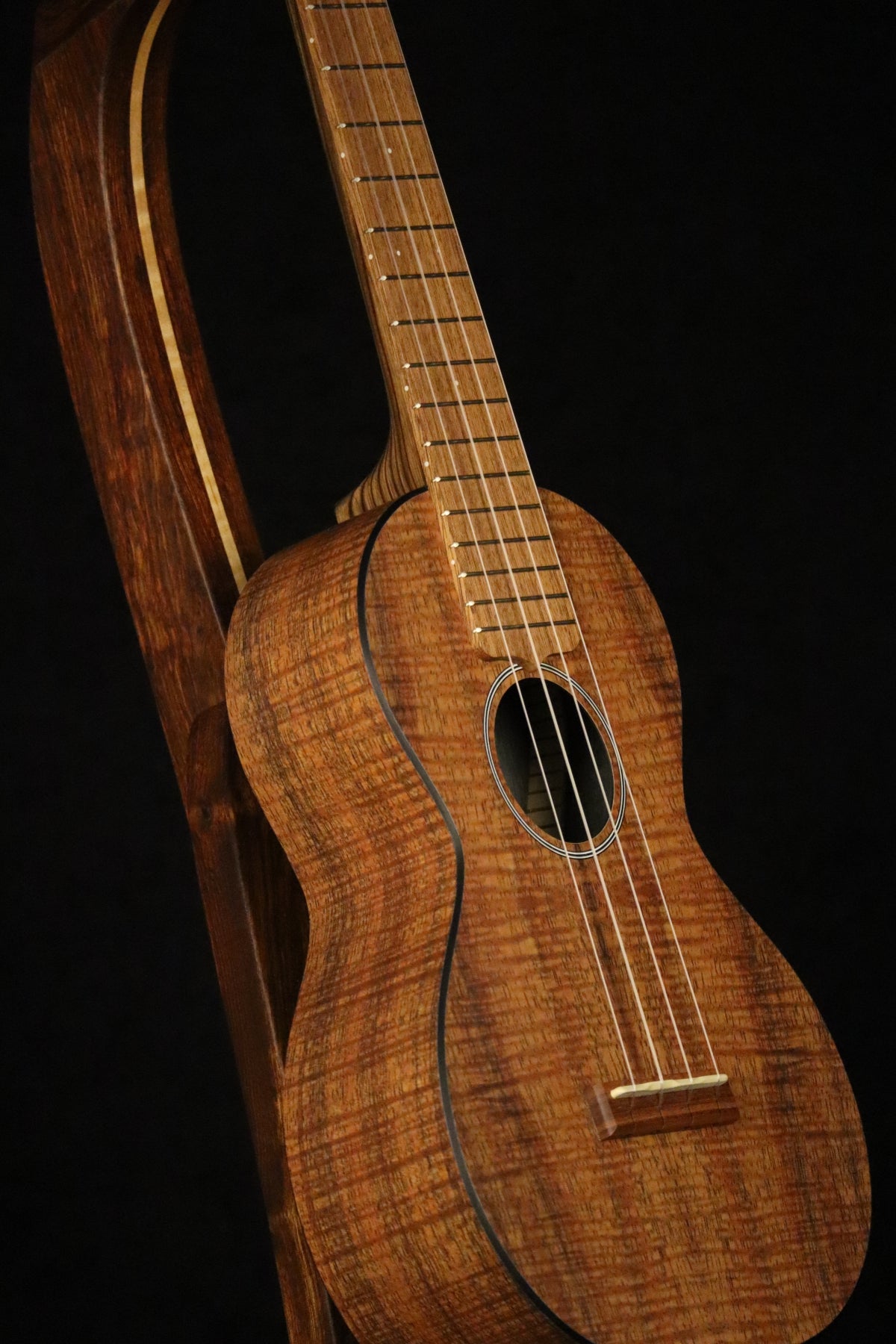 Folding chechen Caribbean rosewood and curly maple wood ukulele floor stand closeup front image with Martin ukulele