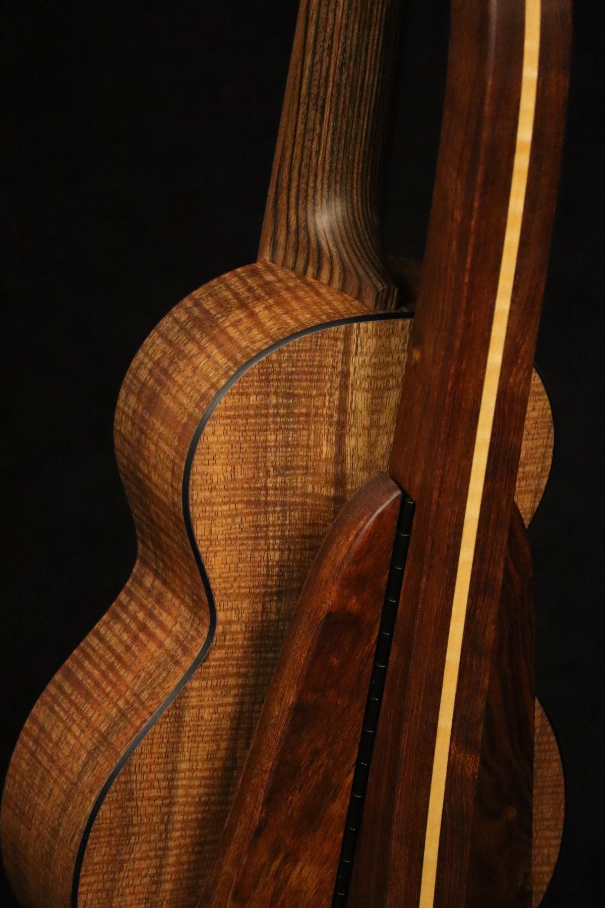 Folding chechen Caribbean rosewood and curly maple wood ukulele floor stand closeup rear image with Martin ukulele