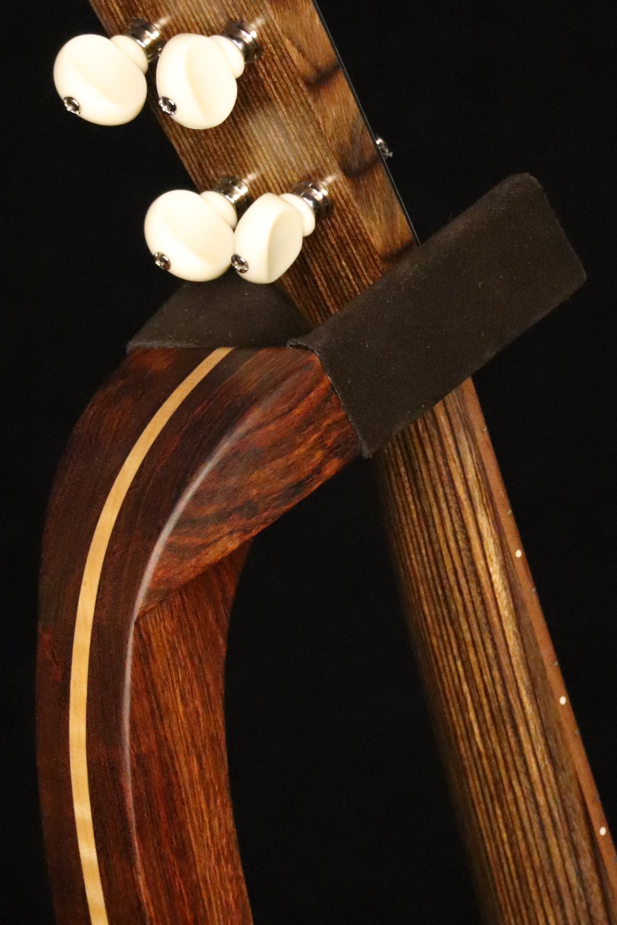 Folding chechen Caribbean rosewood and curly maple wood ukulele floor stand yoke detail image with Martin ukulele