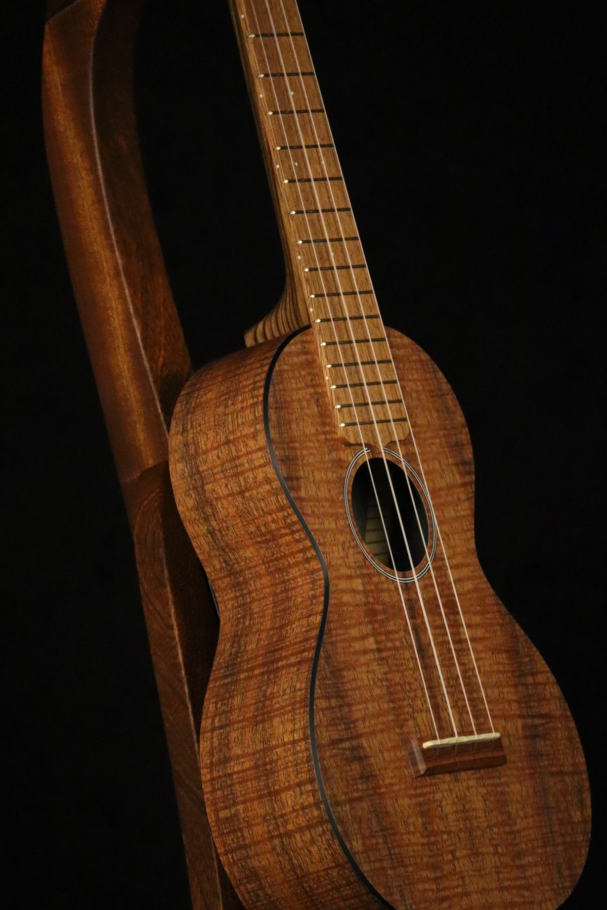 Folding sapele mahogany wood ukulele floor stand closeup front image with Martin ukulele
