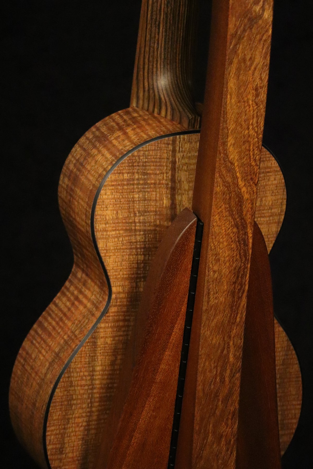 Folding sapele mahogany wood ukulele floor stand closeup rear image with Martin ukulele