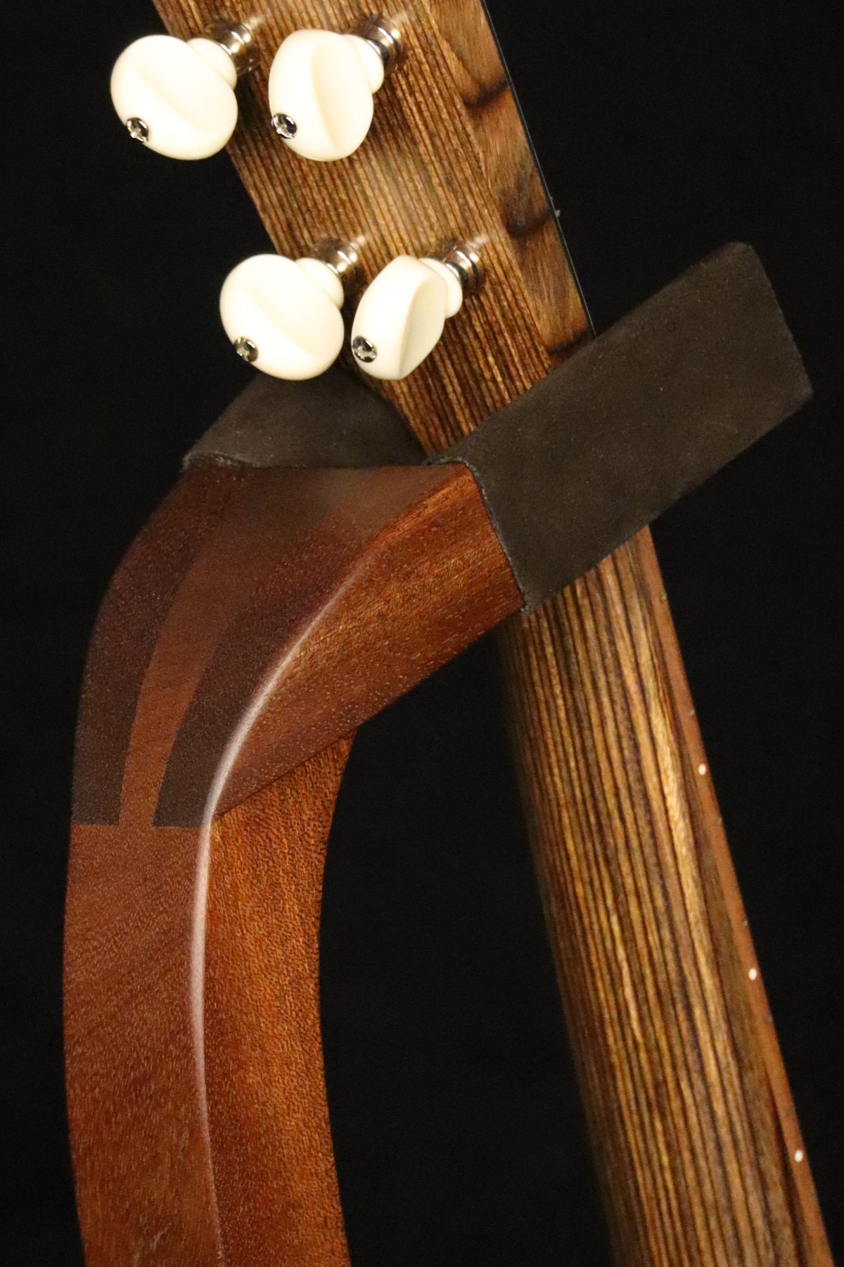 Folding sapele mahogany wood ukulele floor stand yoke detail image with Martin ukulele