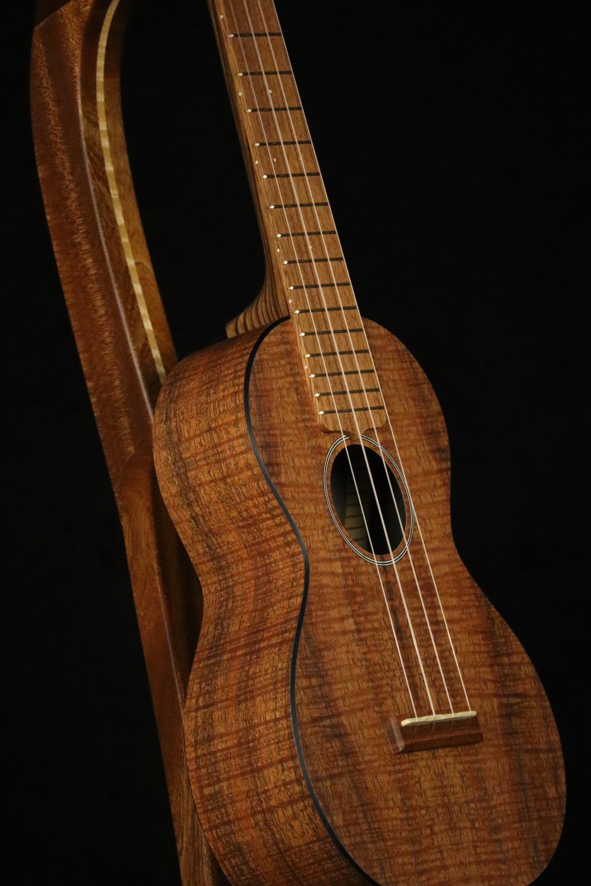 Folding sapele mahogany and curly maple wood ukulele floor stand closeup front image with Martin ukulele