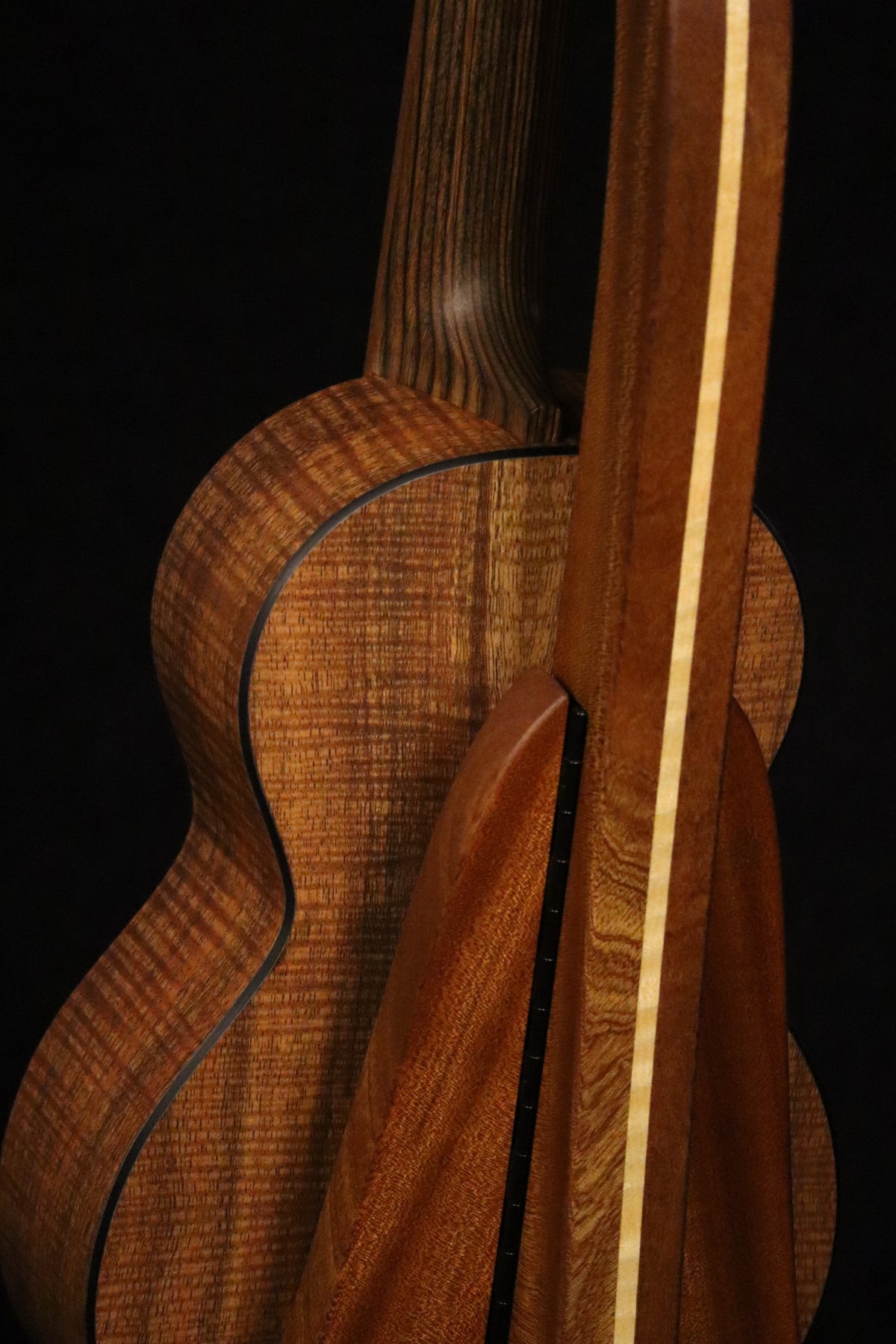 Folding sapele mahogany and curly maple wood ukulele floor stand closeup rear image with Martin ukulele