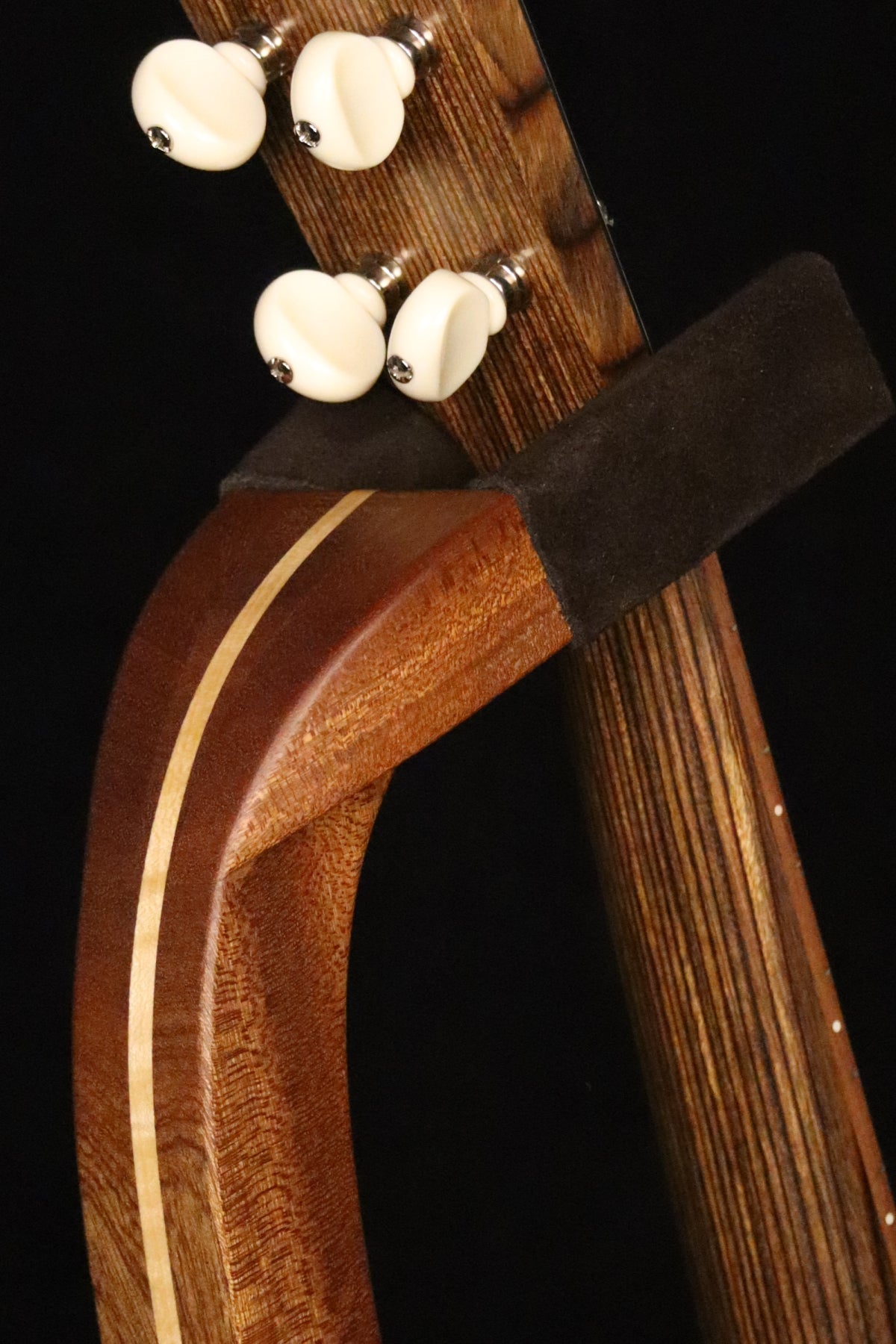Folding sapele mahogany and curly maple wood ukulele floor stand yoke detail image with Martin ukulele