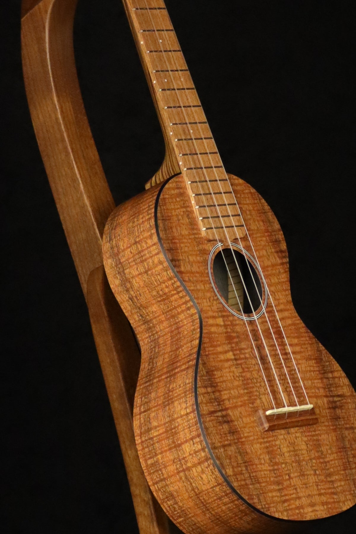 Folding walnut wood ukulele floor stand closeup front image with Martin ukulele