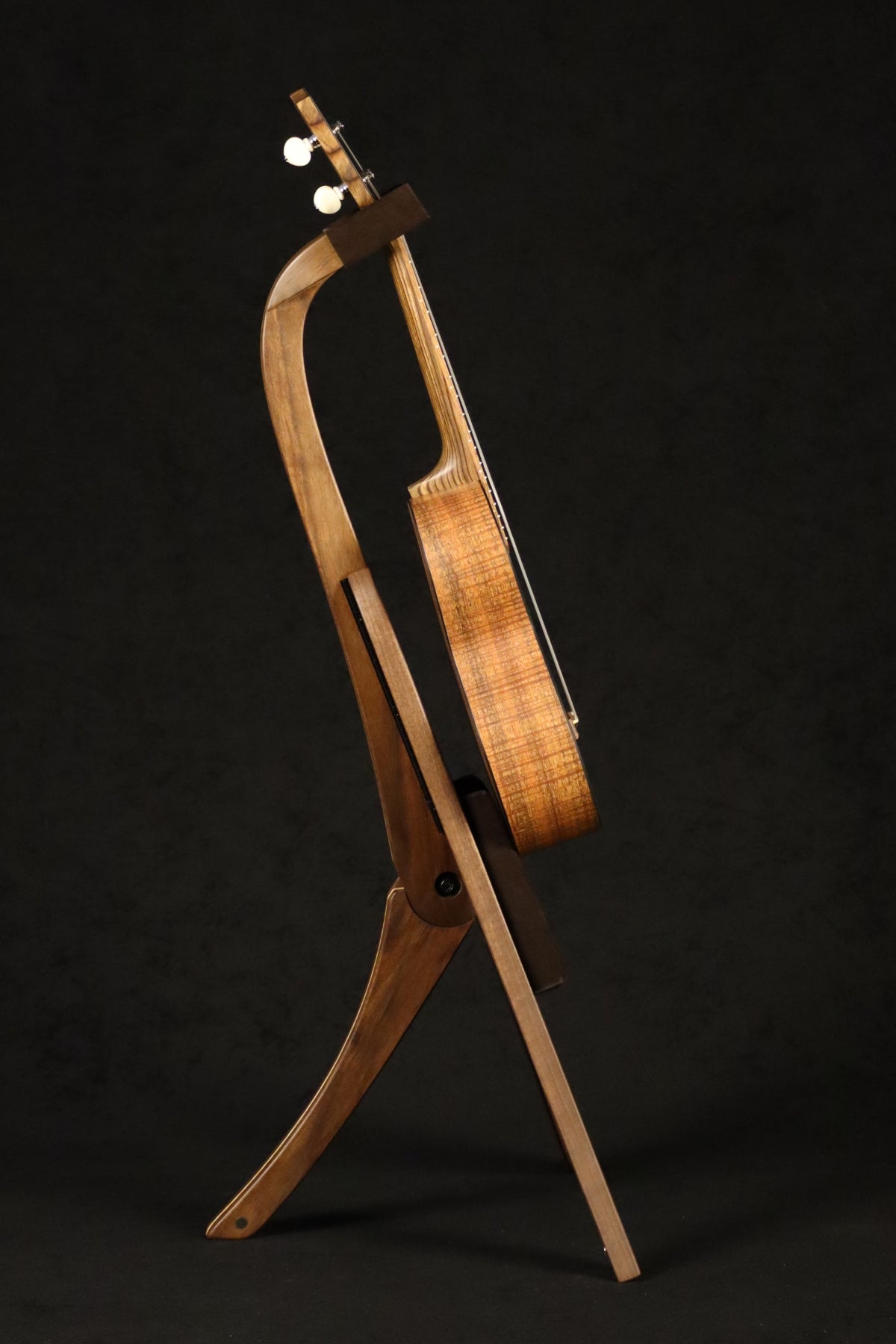 Folding walnut and curly maple wood ukulele floor stand full side image with Martin ukulele