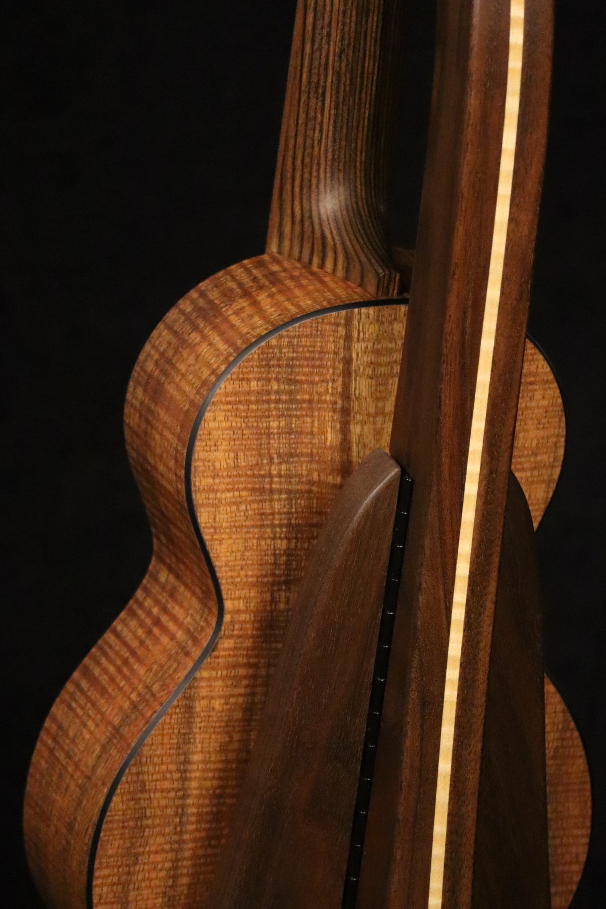 Folding walnut and curly maple wood ukulele floor stand closeup rear image with Martin ukulele