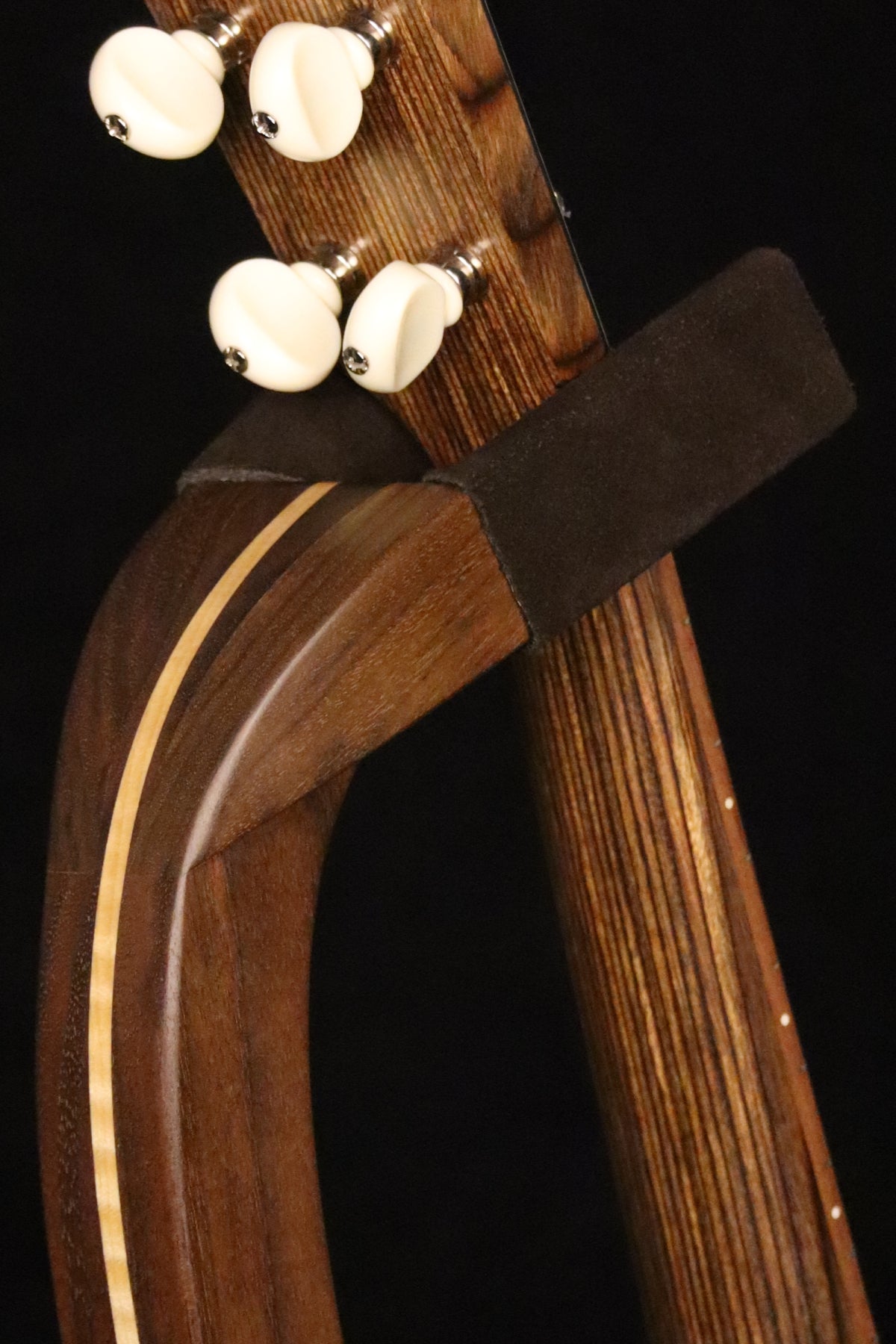 Folding walnut and curly maple wood ukulele floor stand yoke detail image with Martin ukulele